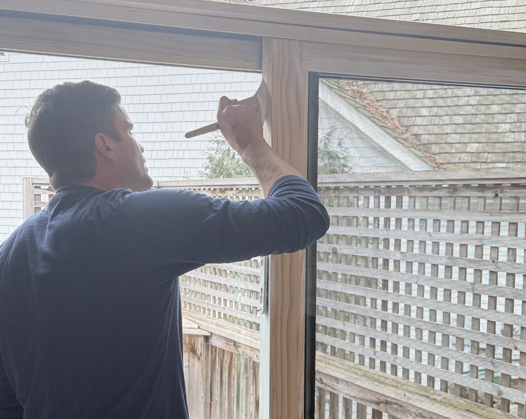 Lakeside Exteriors crew installing a full-frame replacement window on a home in Excelsior, MN